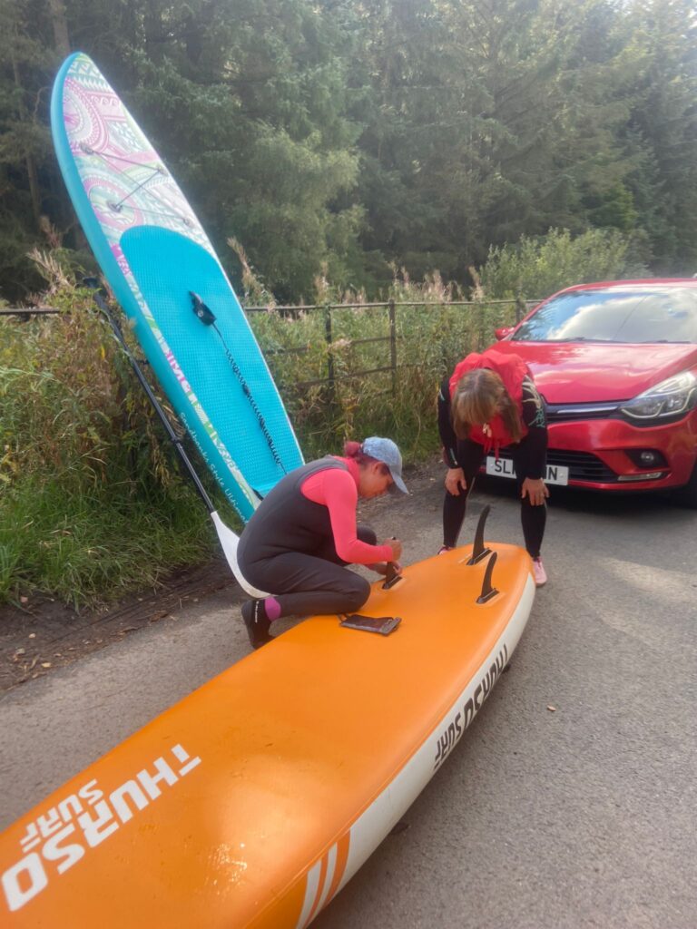 inflating and assembling orange paddle board