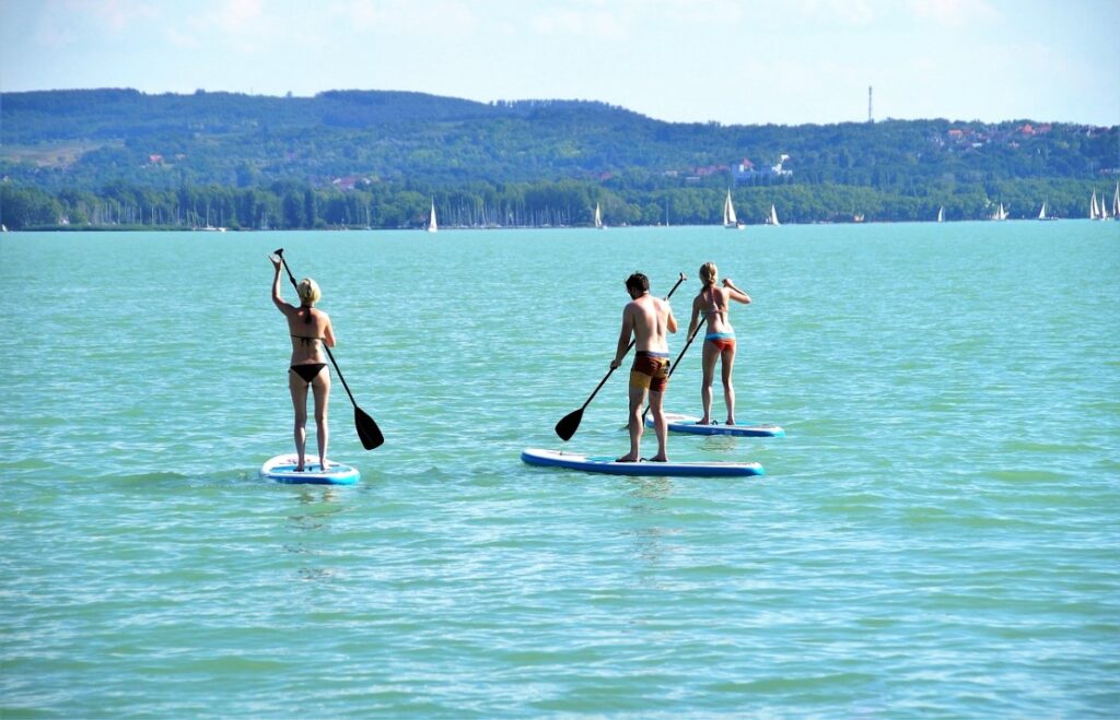 SUP padddleboarders out in the open sea with inflatable paddle boards